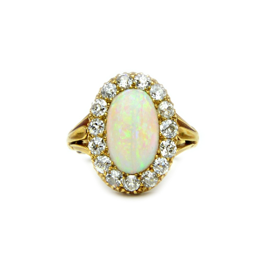 Appraisal: A gold opal and diamond set oval cluster ring mounted