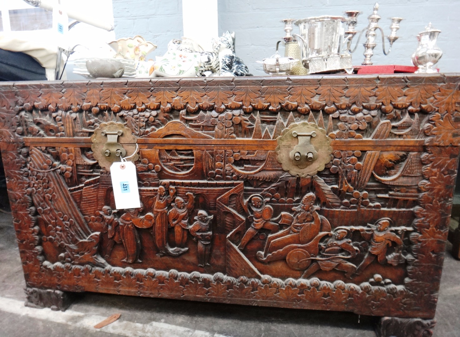 Appraisal: A Chinese highly carved camphorwood chest circa the hinged top