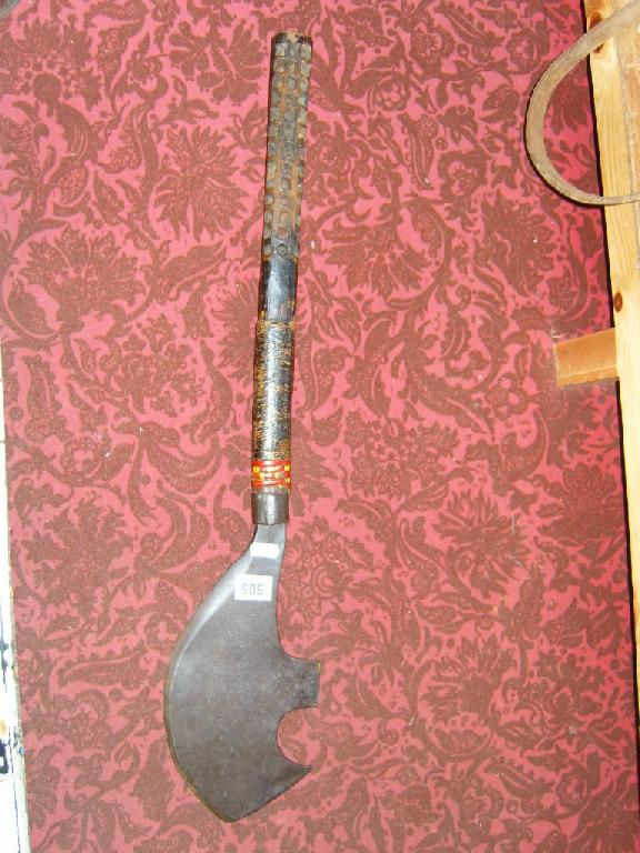 Appraisal: An ethnic ironwork cleaver with shaped blade with carved wooden