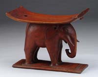 Appraisal: CARVED FIGURAL ELEPHANT STOOL Curved plank seat supported by a