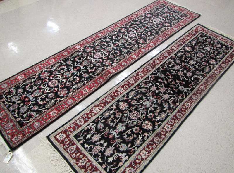 Appraisal: TWO SIMILAR HAND KNOTTED ORIENTAL RUNNERS Indo-Persian overall floral decoration