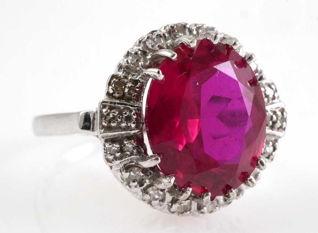 Appraisal: Faceted ruby oval surrounded by round diamonds set in K