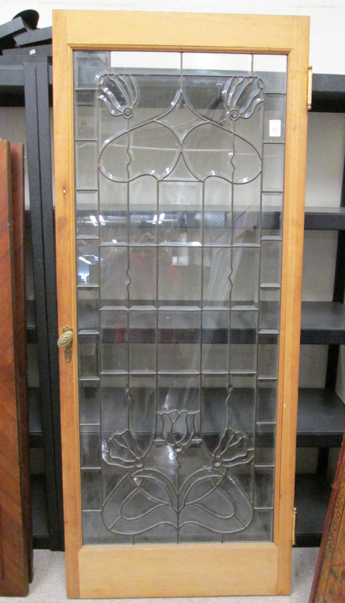 Appraisal: LEADED AND BEVELED GLASS HOUSE DOOR American c a solid