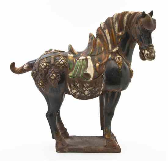 Appraisal: A Tang Style Sancai Glazed Horse standing foursquare on a