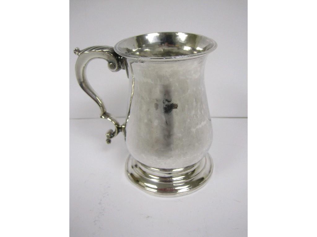 Appraisal: A George III baluster Mug with leafage scroll handle engraved