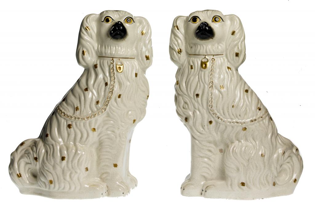 Appraisal: A PAIR OF STAFFORDSHIRE EARTHENWARE MODELS OF SPANIELS in gilt