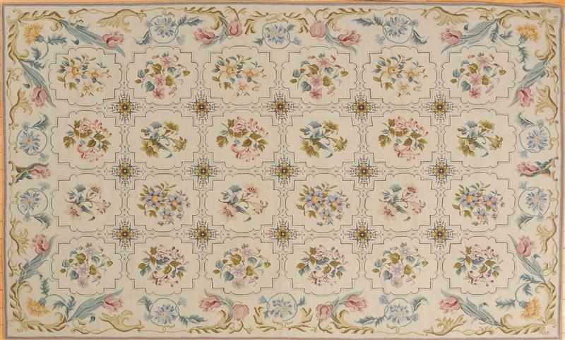 Appraisal: IVORY-GROUND NEEDLEWORK RUG Worked with twenty-four floral tiles within flower