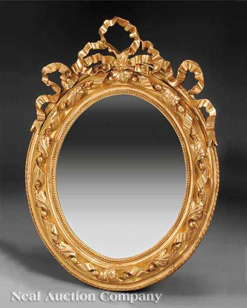 Appraisal: An Italian Carved and Gilded Oval Mirror carved beribboned frame