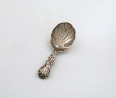 Appraisal: A Victorian provincial silver caddy spoon King's shape with scroll