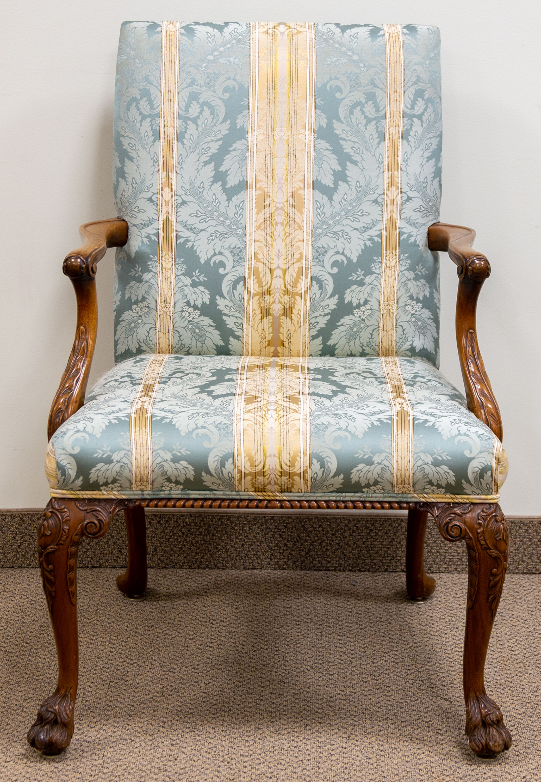 Appraisal: ENGLISH WALNUT ARMCHAIR th century with carved paw feet and