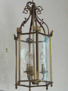 Appraisal: A hexagonal brass hall lantern with incurved glass panels measurements