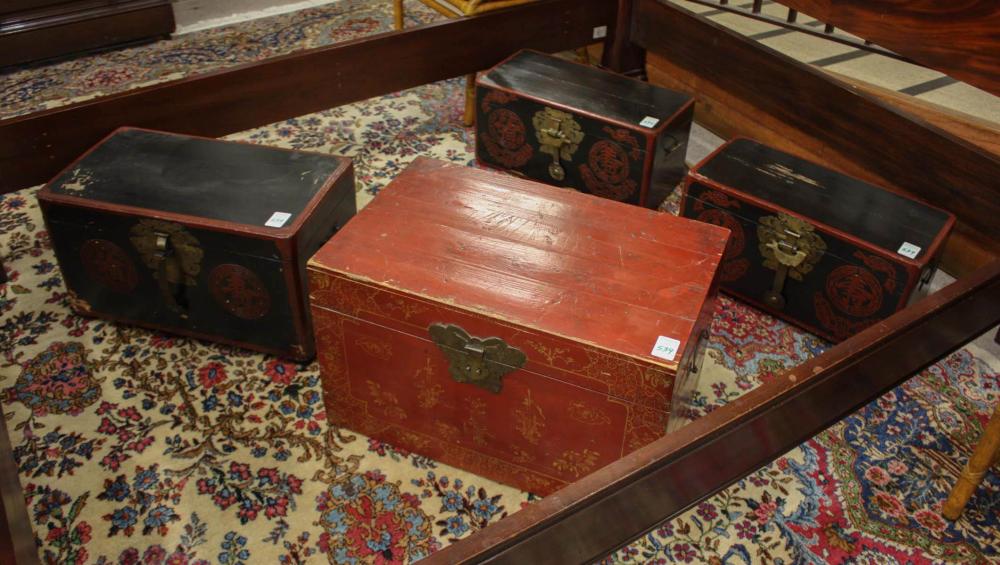 Appraisal: FOUR CHINESE LIFT-TOP STORAGE TRUNKS the largest with gold decoration