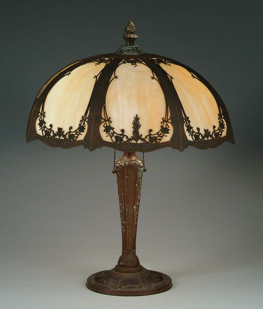 Appraisal: BENT PANEL TABLE LAMP Decorative shade has cast metal frame