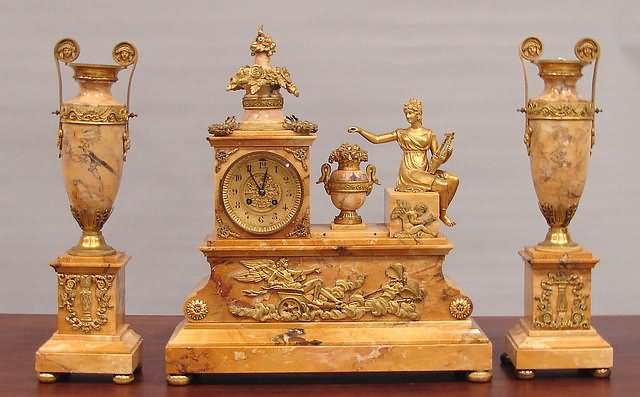 Appraisal: Bronze and marble three piece set butterscotch marble clock adorned