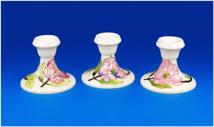 Appraisal: Moorcroft Pair of Candlesticks and Single Similar Pink Magnolia on