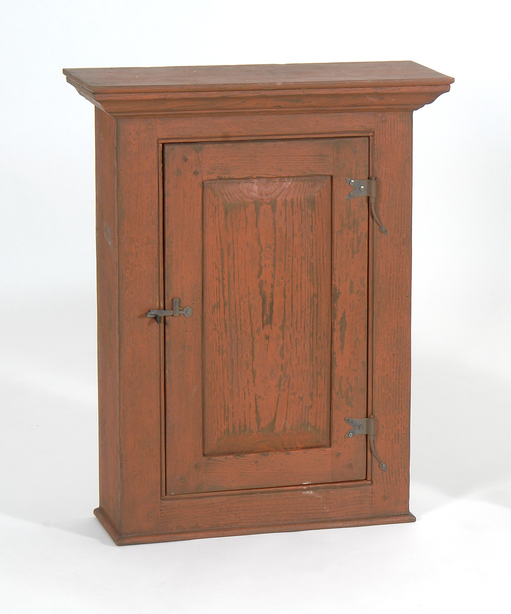 Appraisal: WALL-MOUNTED ONE-DRAWER CABINET in pine Paneled door with iron hardware