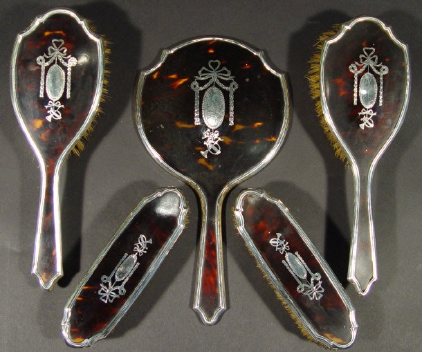 Appraisal: Edwardian silver and tortoiseshell five piece dressing table set inlaid