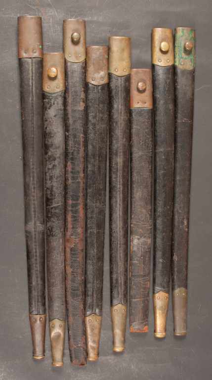 Appraisal: Eight scabbards circa - black leather with brass mounts Estimate