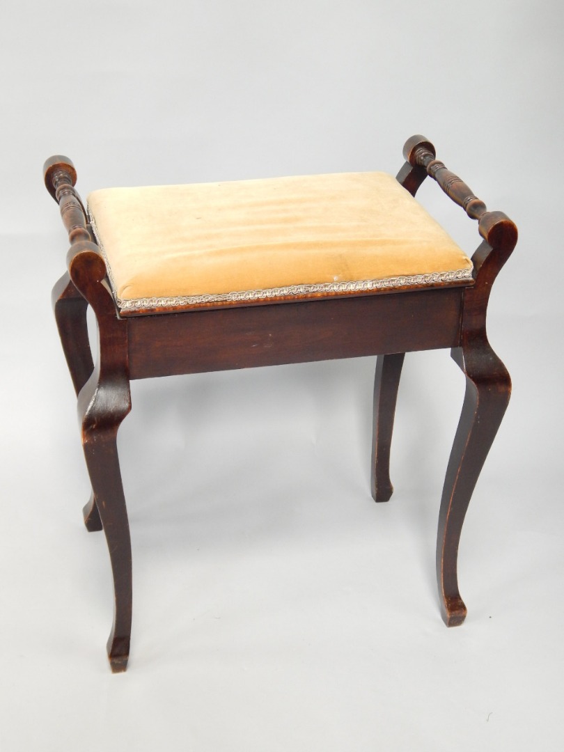 Appraisal: A mahogany piano stool with hinged music locker seat and