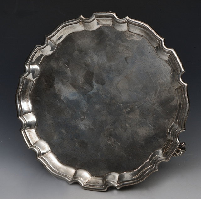 Appraisal: A SILVER WAITER with a Chippendale style border standing on