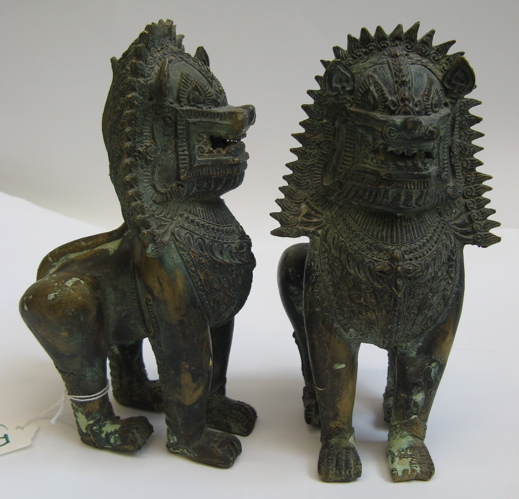 Appraisal: PAIR ASIAN BRONZE SCULPTURES stylized fierce lion creatures standing pose