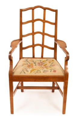 Appraisal: A walnut armchair of Cotswold School design with trellis back