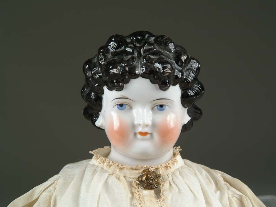 Appraisal: GERMAN CHINA HEAD DOLL Black haired china with elaborately molded