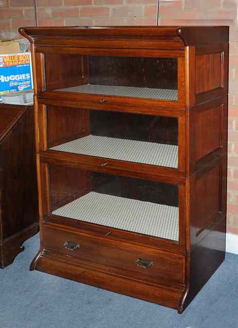 Appraisal: A GLOBE WERNICKE STYLE THREE SECTIONAL BOOKCASE with base drawer