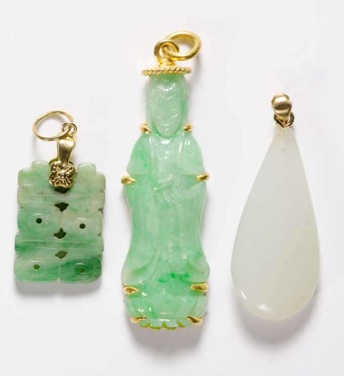 Appraisal: THREE JADE AND FOURTEEN KARAT GOLD PENDANTS measuring inches -