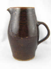 Appraisal: An art pottery West Country stoneware jug with strap handle