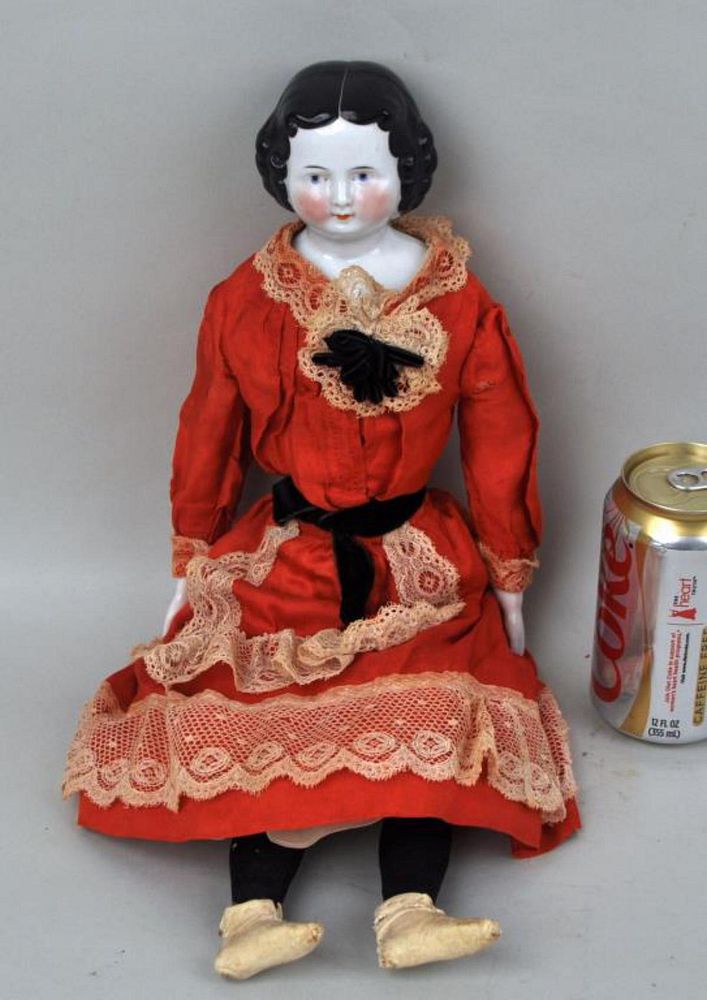 Appraisal: German Glazed Porcelain Flat Top Doll with red cloth dress