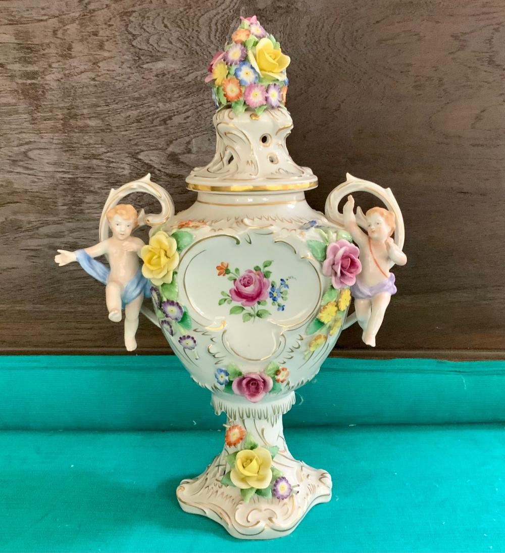 Appraisal: German Schierholz Floral Encrusted Porcelain Two Putti Handle Potpourri Urn