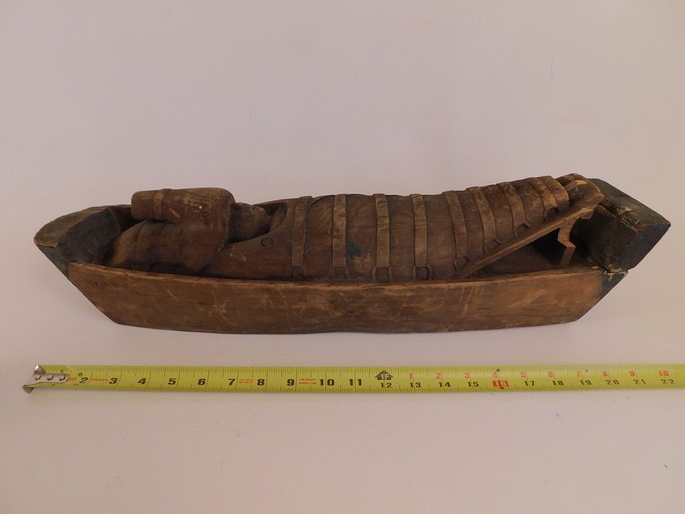 Appraisal: NATIVE AMERICAN BABY IN BOAT CARVING Antique carved wood baby