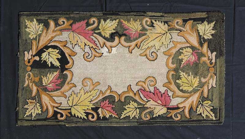 Appraisal: LEAF MOTIF HOOKED RUG Central tan field surrounded by yellow