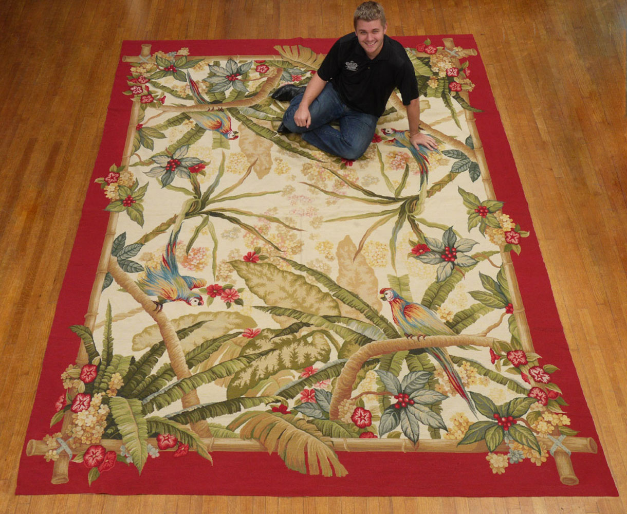 Appraisal: LARGE TROPICAL THEMED NEEDLEPOINT RUG ' X ' Red border