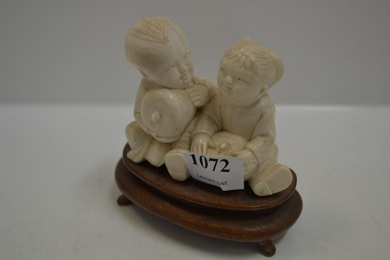 Appraisal: SMALL CHINESE CARVED IVORY FIGURE OF TWO CHILDREN WITH APPLES