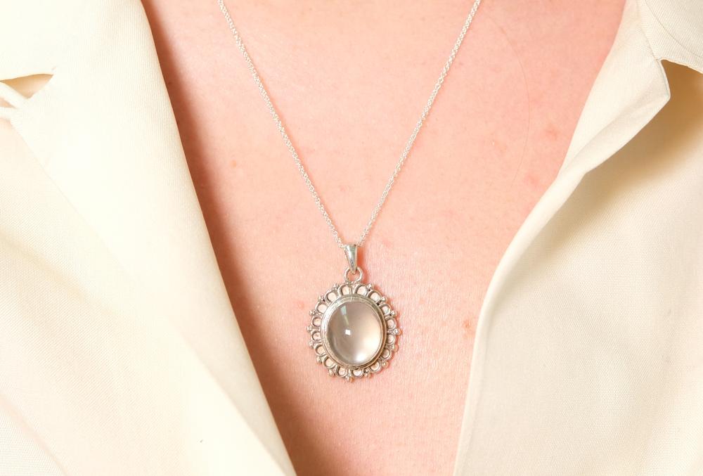 Appraisal: Sterling silver necklace hung with a oval Moonstone cabochon pendant