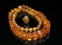 Appraisal: An Amber Beaded Necklace and Ring A necklace made of