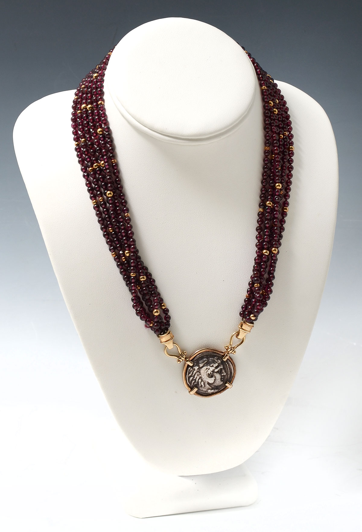 Appraisal: K GARNET BEAD ROMAN COIN NECKLACE Six strands of mm