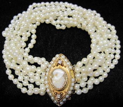 Appraisal: karat yellow gold pearl diamond and cameo braceletNine strand pearl