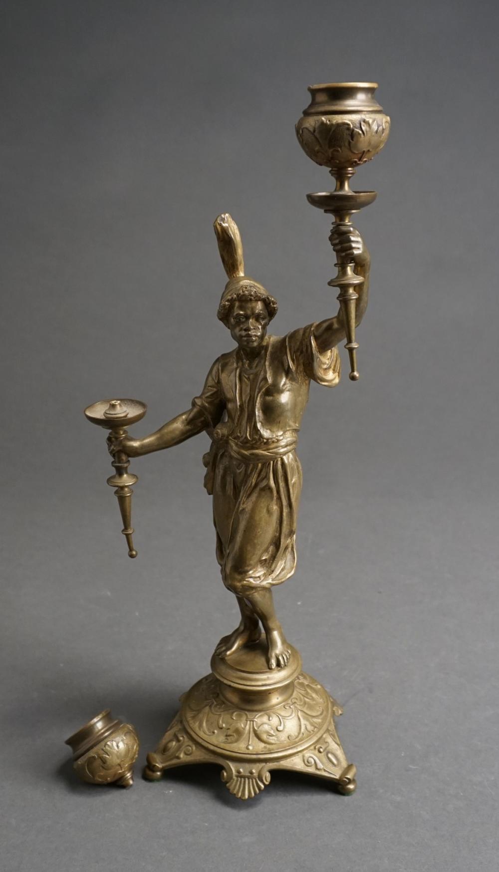 Appraisal: Patinated Metal Figure of Torchbearer Two-Light Candelabrum One light broken