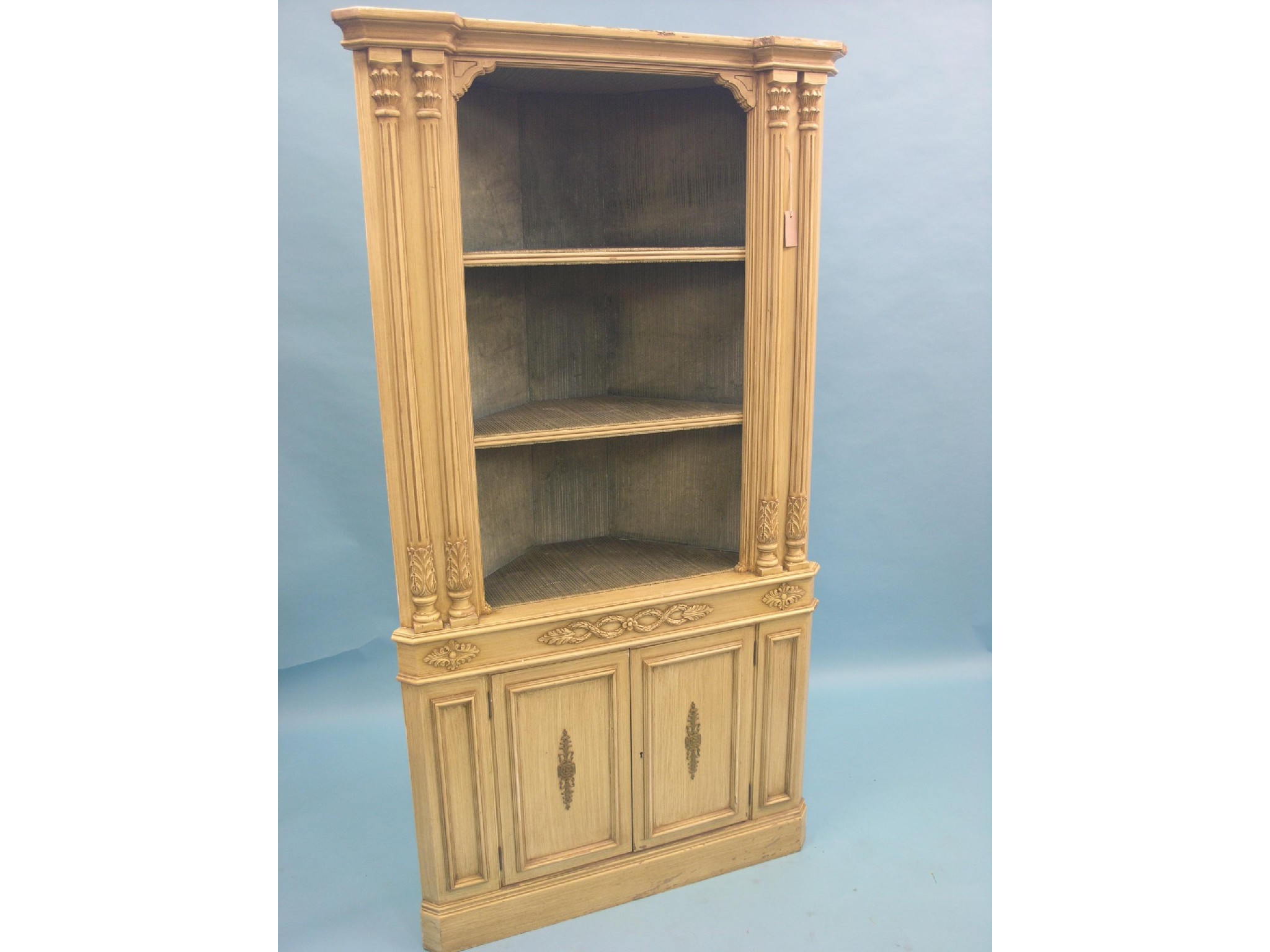 Appraisal: A period-style cream-finished corner cabinet lined interior with two open