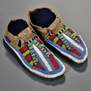 Appraisal: Lakota Beaded Buffalo Hide Moccasins c s with bold multicolored