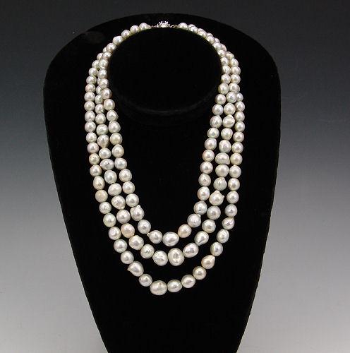 Appraisal: A TRIPLE STRAND NECKLACE OF SILVER BAROQUE PEARLS - mm