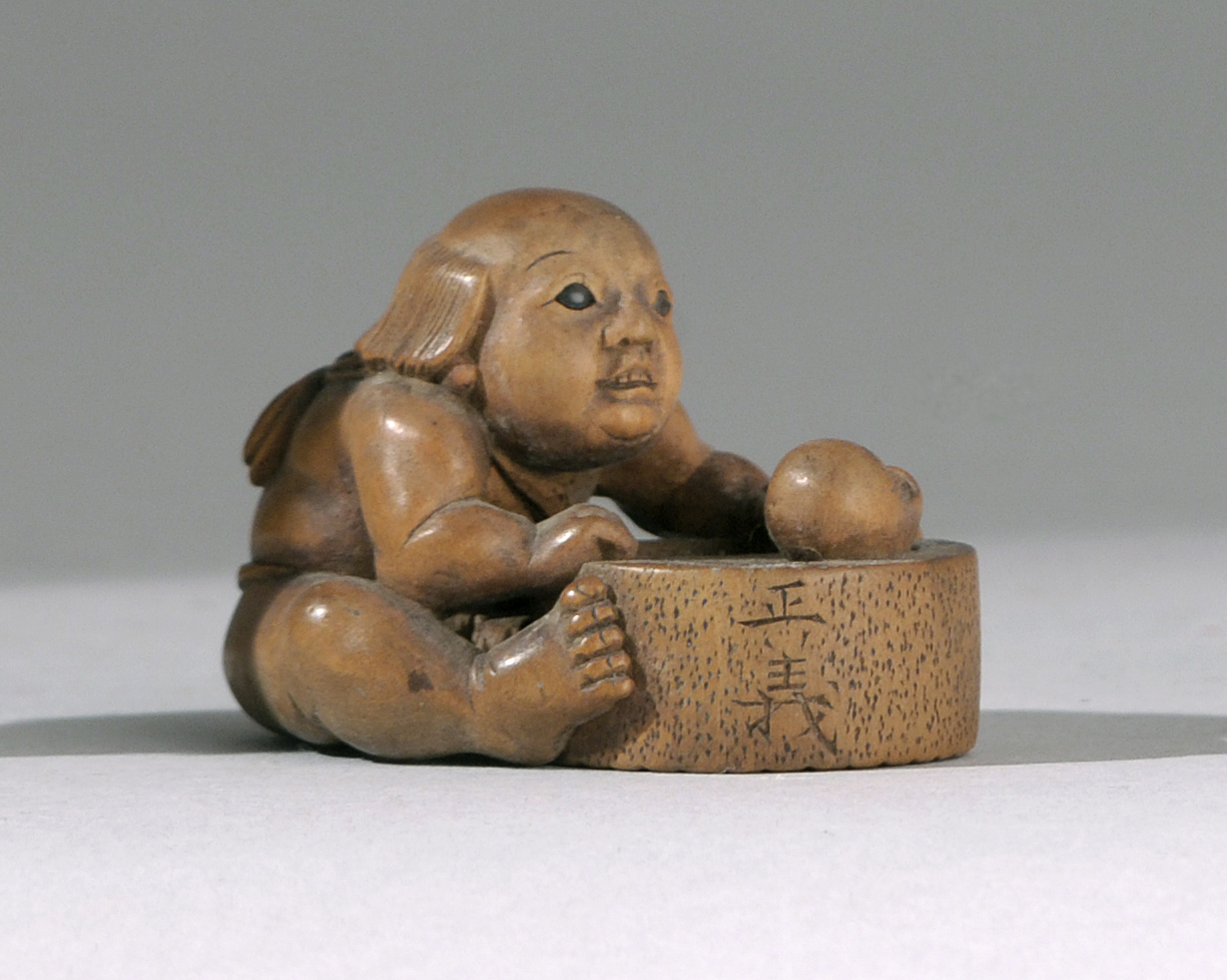 Appraisal: WOOD NETSUKE Edo PeriodBy Masayoshi Depicting Kintaro with inlaid eyes