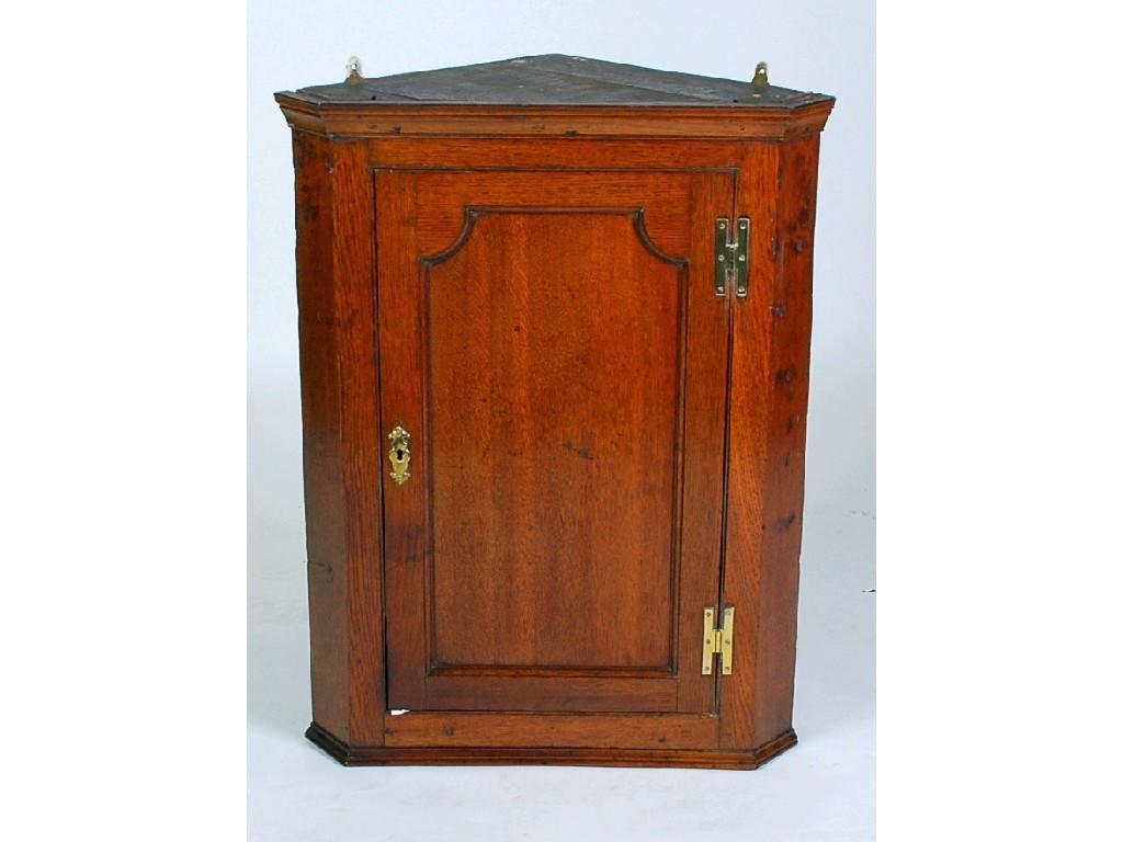 Appraisal: GEORGE III OAK CORNER CUPBOARD the moulded cornice above a