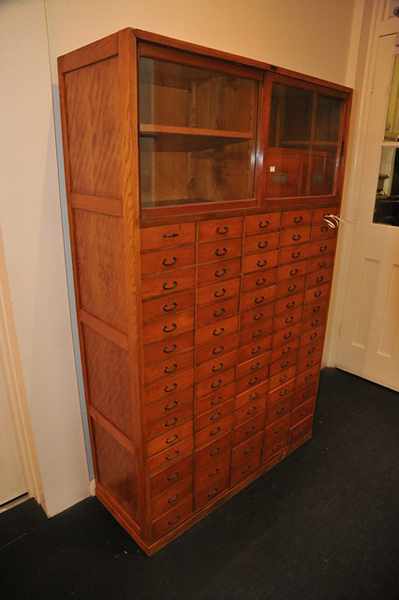 Appraisal: A JAPANESE CEDAR HERBALIST CABINET OF SEVENTY DRAWERS AND TWO