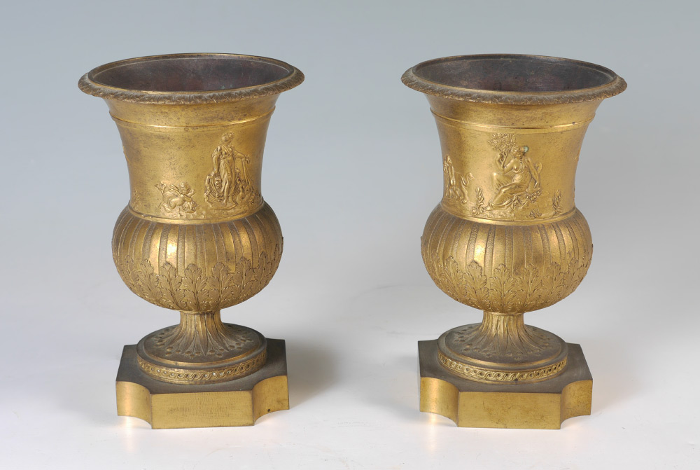 Appraisal: PAIR TH CENTURY PARCEL GILT URNS Low relief neoclassical scene