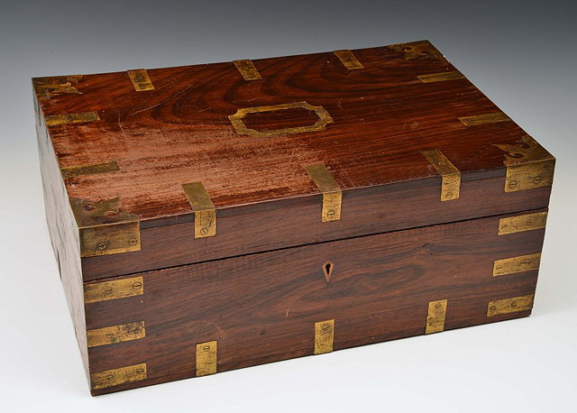 Appraisal: AN INDIAN COLONIAL HARDWOOD WRITING BOX with fitted compartment interiors