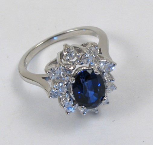 Appraisal: SAPPHIRE AND FOURTEEN KARAT GOLD RING centering an oval-cut blue